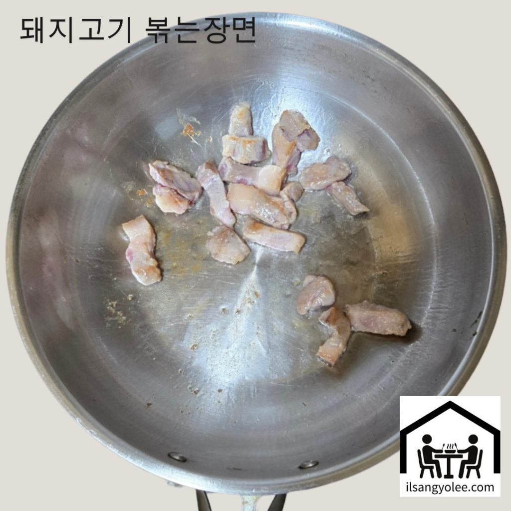 냄비에 돼지고기 앞다리살을 넣고 볶기 시작하는 모습