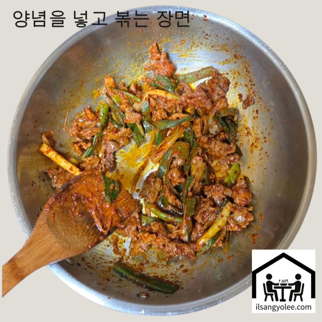 팬에서 파기름과 함께 소고기, 고춧가루를 볶는 모습